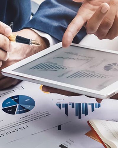 Advisors reviewing financial charts on a tablet